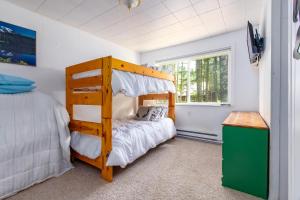 a small bedroom with a bunk bed and a window at Peak View | White Pass, Mt Rainier in Packwood