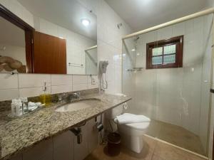 a bathroom with a sink and a toilet at Pousada Flor de Lua Monte Verde in Monte Verde +172 photos