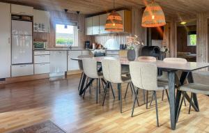a kitchen with a dining table and chairs at Holiday Home Strandlyst Vinderup I in Vinderup