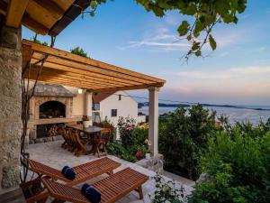 a patio with a table and chairs and a fireplace at Apartment Fortuno - One Bedroom Apartment with Terrace and Sea View in Mlini