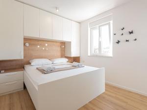 a white bedroom with a large white bed in it at Holiday Home Iva - Three Bedroom Holiday Home in Šibenik +25 photos