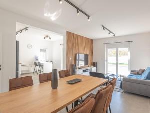 a dining room and living room with a table and chairs at Holiday Home Iva - Three Bedroom Holiday Home in Šibenik
