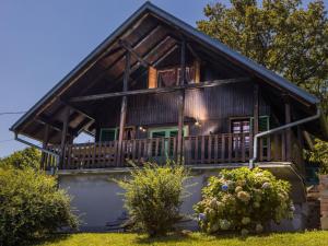 a log home with a porch and a balcony at Holiday Home MILa - Duplex one bedroom Holiday Home with Terrace in Stubicke Toplice
