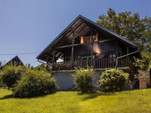 a large wooden house with a porch on a lawn at Holiday Home MILa - Duplex one bedroom Holiday Home with Terrace in Stubicke Toplice