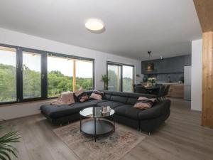 a living room with a couch and a table at Holiday Home Arbaro - Three Bedroom Holiday Home with Pool in Kravarsko