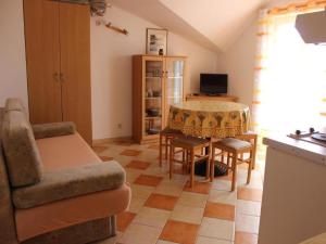 a living room with a couch and a table at Apartments Pansion Franka 3 - Apartment 11 in Brist