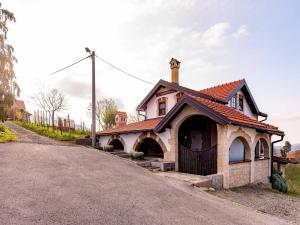 a house sitting on the side of a road at Holiday home with hot tube and 1 room in Donja Stubica