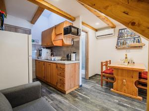 a kitchen with wooden cabinets and a wooden table at Sleek and Stylish Umag Apartments with Sea View - Comfort Two Bedroom Apartment with Terrace in Umag