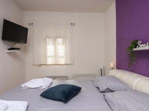 a bedroom with a bed with two pillows on it at Vila Ive winter spa Podumci in Podumci +58 photos