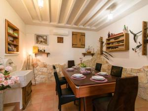 a kitchen and dining room with a table and chairs at Vila Ive winter spa Podumci in Podumci