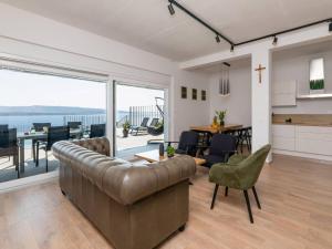 a living room with a leather couch and a dining room at Spectacular Bol Island Sea View Villa with Pool - Four Bedroom Villa with Pool in Bol