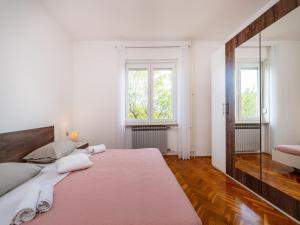 a bedroom with a large bed and two windows at Five Bedroom Villa in Zadar +39 photos