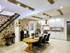 a kitchen and dining room with a wooden table and chairs at Villa Nika - Three Bedroom Villa with Private Pool in Lozovac