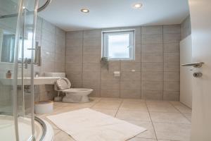 a bathroom with a toilet and a sink and a shower at Holiday Home Lea - Three Bedroom Holiday Home with Terrace and Sea View in Maslinica +52 photos