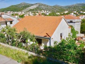 a white house with an orange tile roof at Three Bedroom Apartment with Terrace in Seget Vranjica