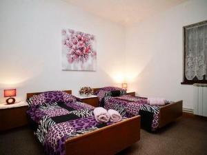 a hotel room with two beds with pink pillows at Three Bedroom Apartment with Terrace in Seget Vranjica