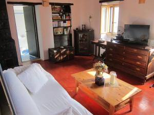 a living room with a white couch and a wooden table at Villa Bella - Two Bedroom House in Grožnjan