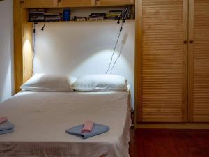 a bedroom with a bed with two slippers on it at Villa Bella - Two Bedroom House in Grožnjan
