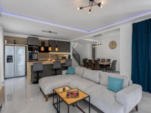 a living room with a couch and a kitchen at Villa Fran - Four Bedroom Villa with Private Pool in Šmrika