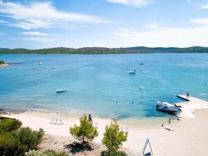 a view of a beach with a boat in the water at Gabrijela House - House in Pirovac