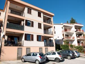 a group of cars parked in front of a building at Cozy Icici Apartment with Sea view - Two Bedroom Apartment with Sea View in Ičići