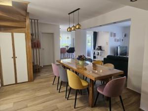 a dining room and living room with a wooden table and chairs at Vlla Magnolia Pirovac in Pirovac
