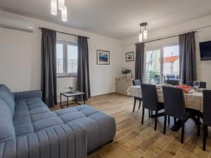 a living room with a blue couch and a table at Holiday Home Milutin 1 - Four Bedroom Holiday Home with Private Pool in Vrsi