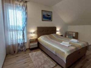 a bedroom with a large bed and a window at Villa Tamaris - Two Bedroom Holiday Home with Terrace and Swimming pool in Mali Drvenik