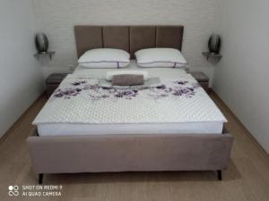 a bedroom with a large bed with purple flowers on it at Villa Ava - Five Bedroom Villa with Swimming pool in Šibenik +33 photos