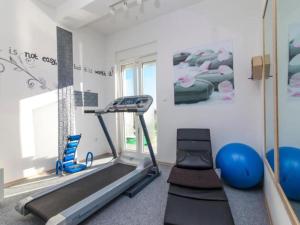 a gym with a treadmill and pilates equipment in a room at Villa Ava - Five Bedroom Villa with Swimming pool in Šibenik