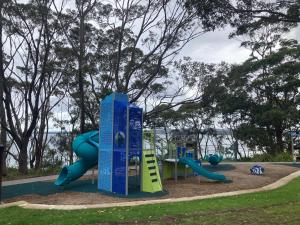 a playground with a slide in a park at Hyams Beach - A Secret Treasure in Hyams Beach