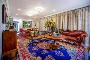 a living room with a couch and a table at Batavia Boutique Hotel in Stellenbosch