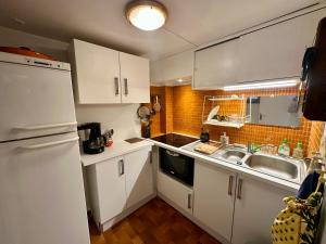 a small kitchen with white cabinets and a sink at Appartement T4 Duplex 60m², 6 Pers, Vue Lac & Montagnes - FR-1-758-40 in Les Angles +5 photos
