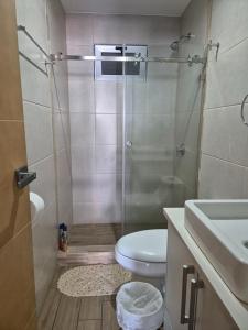 a bathroom with a shower with a toilet and a sink at Apartamento en City Haus Guatemala in Estación Pamplona +15 photos