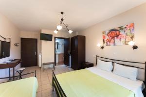 a hotel room with a bed and a desk at Kipos Resort in Nea Peramos