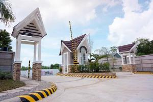a small church with a yellow and white building at Kate Residence House in Dao