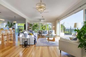a living room with a couch and a table at Palm Springs in Waiheke Island