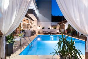 a swimming pool in the middle of a house at Kipos Resort in Nea Peramos