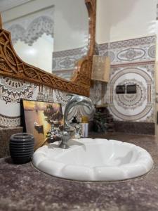 a bathroom with a sink and a mirror at Airport Apartment 5 minutes walk, perfect for Early & Late Flights in Marrakech