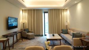 a living room with a couch and a table at Address Beach Resort Fujairah Apartment Three Bedrooms by Blue World- 1 in Fujairah