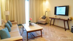 a living room with a couch and a tv at Address Beach Resort Fujairah Apartment Three Bedrooms by Blue World- 1 in Fujairah +9 photos