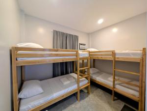 a dorm room with three bunk beds in it at The Canyoneer Inn in Alegria