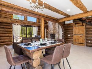 a dining room with a stone table and chairs at Holiday Home Elizabeta in Slunj