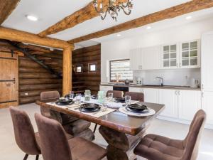 a kitchen and dining room with a wooden table and chairs at Holiday Home Elizabeta in Slunj +10 photos