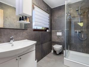 a bathroom with a sink and a toilet and a shower at Holiday Home Elizabeta in Slunj