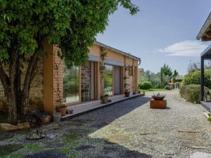 a house with a tree in front of it at Poolside Grand Retreat Villa in Vošteni
