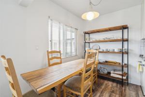 a dining room with a wooden table and chairs at Beautiful 2 Bed Beach Condo #203 in Carpinteria
