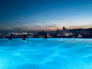a swimming pool with a city skyline in the background at Calyx Residences High End 1 Bedroom Unit in Cebu City