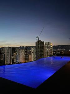 a view of a city at night with blue lights at Calyx Residences High End 1 Bedroom Unit in Cebu City