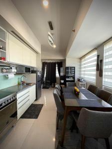 a kitchen with a table and chairs in a room at Calyx Residences in Cebu City